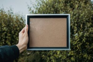 A hand holding a picture frame