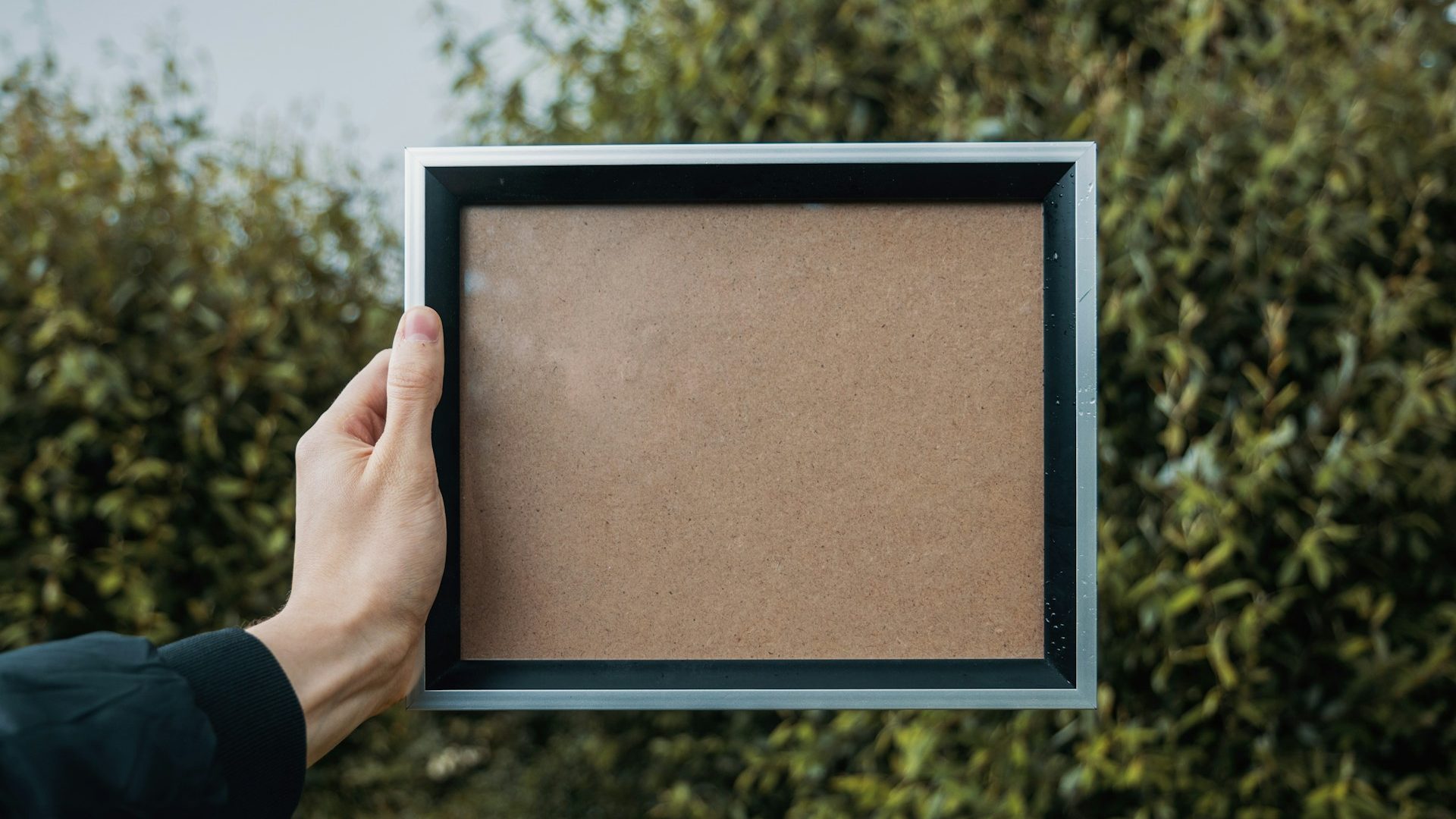 A hand holding a picture frame